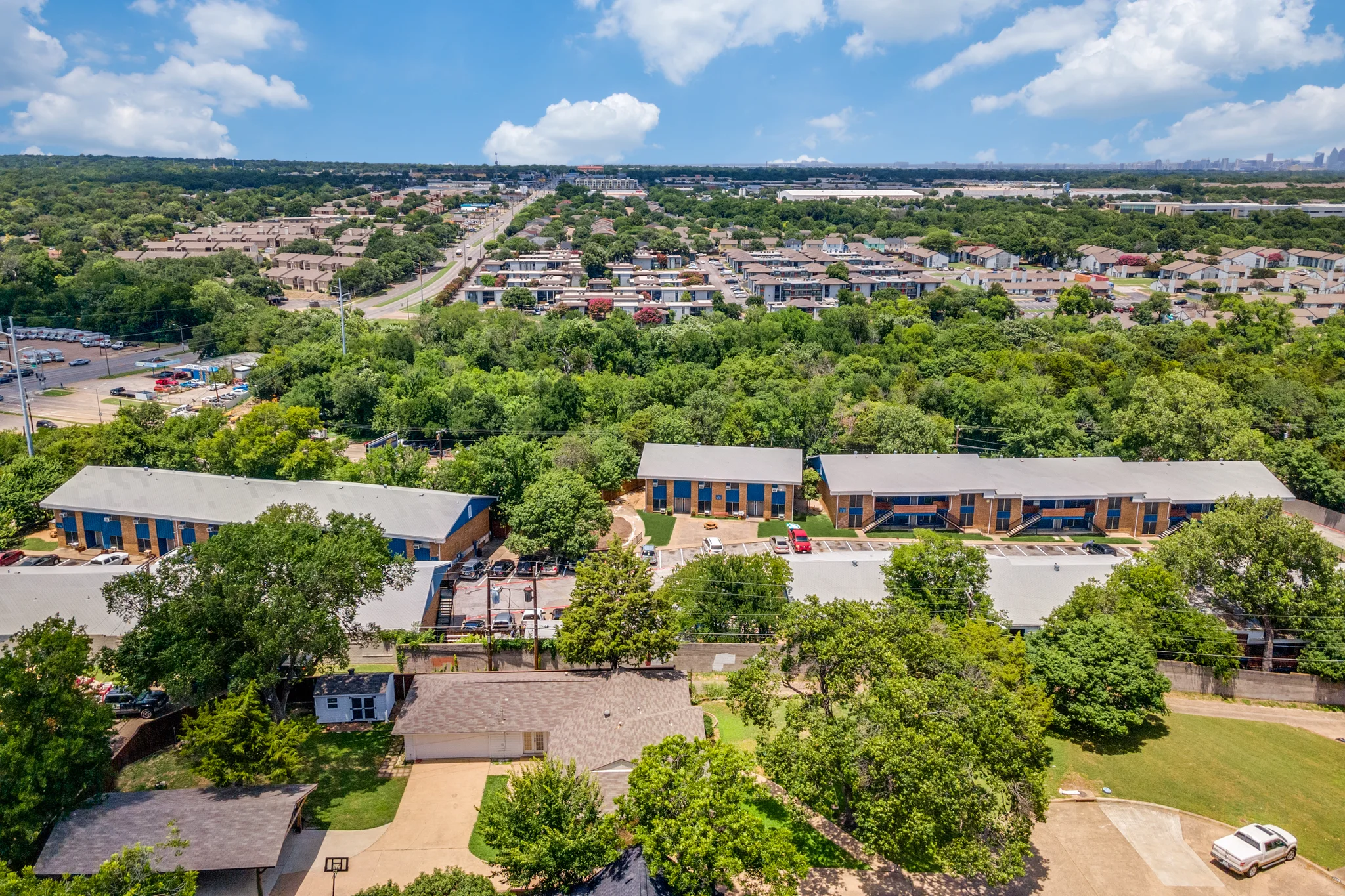 The property from the air with the neighborhood street running past it.